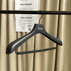 Custom black plastic hanger with non-slip foam trouser bar and shoulder grips, custom printed brand logo, hanging on clothing rack for apparel retail display