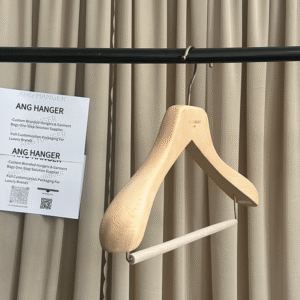 Custom wooden coat hangers hanging on retail display rod