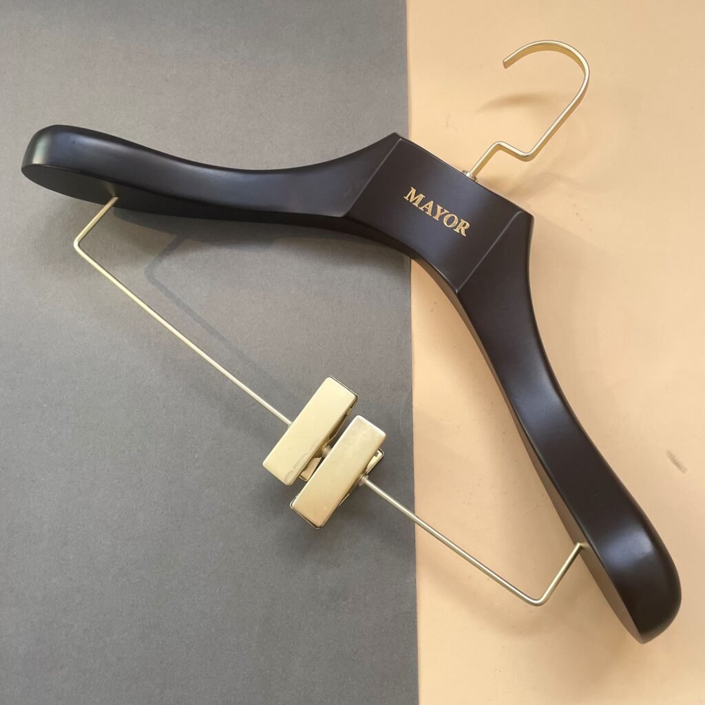 Customized black wooden clip hangers with gold hardware and engraved logo for suits and pants