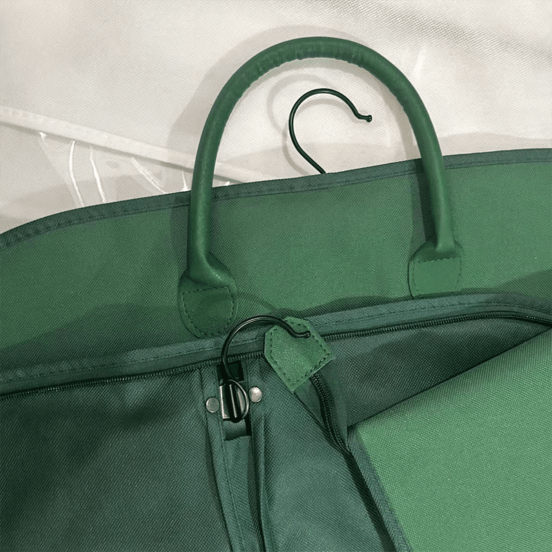 Green oxford hanging clothes bags wholesale with built-in hanging hook and carry handle, close-up of durable zippered garment cover for apparel retail brands