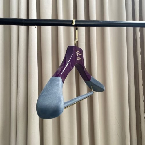 Purple glossy custom wooden suit hanger with velvet shoulder pads and gold logo for luxury apparel brands