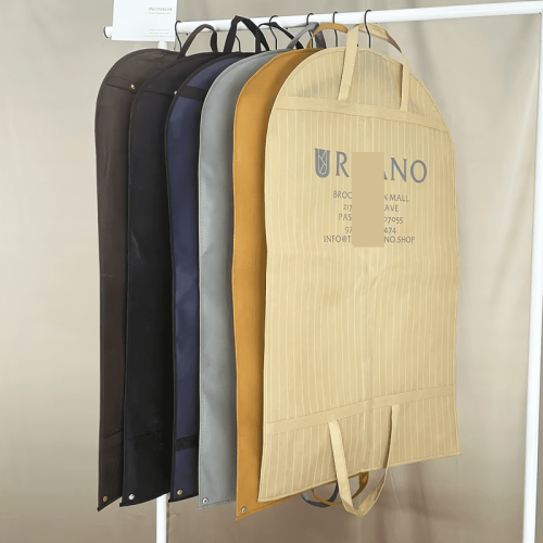Multiple men suit dust bags wholesale in assorted colors and fabrics, hanging garment covers with custom printed brand logo and carry handles for menswear brands and tailor shops