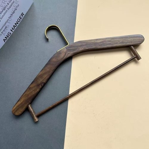Wholesale wooden hanger in walnut wood finish with integrated solid wood trouser bar and polished brass metal hook, premium flat-lay suit hanger for apparel retail and boutique display