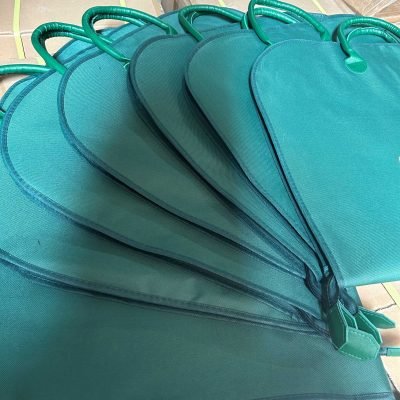 Solid green hanging clothes bags wholesale in blank bulk style, durable oxford fabric garment covers with carry handles for apparel brands
