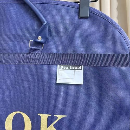 Navy men suit dust bags wholesale with reinforced carry handle and identification label, durable non-woven suit cover with custom gold print for menswear retail brands